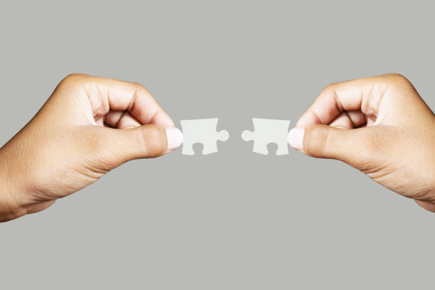istock Close up holding one puzzle element wrong or not connected isolated on gray background. High-resolution product. 1350817794