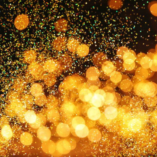 istock Luxury golden glitters on dark background. Bokeh effect 1350818148