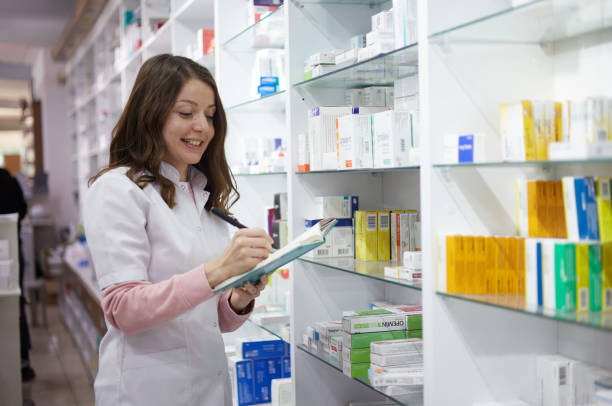 istock A woman using a note to do inventory in a pharmacy 1350821618