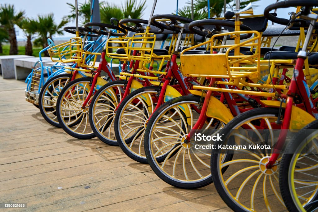 Bicycle rental for cycling along the embankment. Bicycle parking for the whole family Bicycle rental for cycling along the embankment. Bicycle parking for the whole family. Tricycle Stock Photo