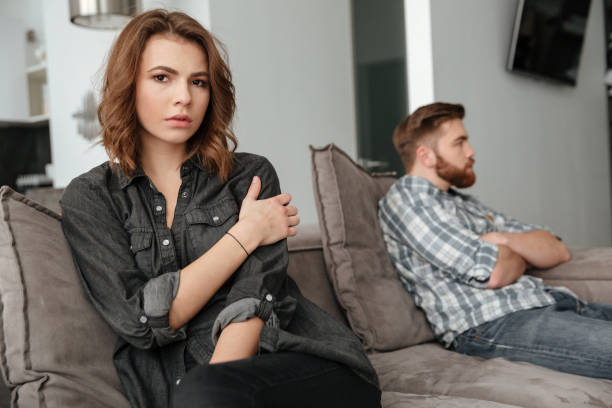 istock Sad quarrel loving couple sitting on sofa indoors. 1350822321