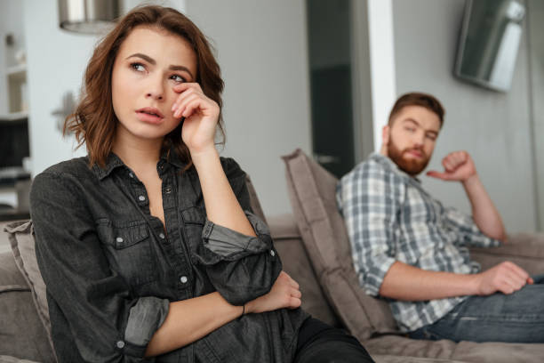 istock Sad quarrel loving couple sitting on sofa indoors. 1350822558