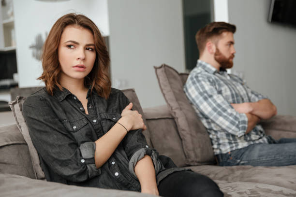 istock Sad quarrel loving couple sitting on sofa indoors 1350822684