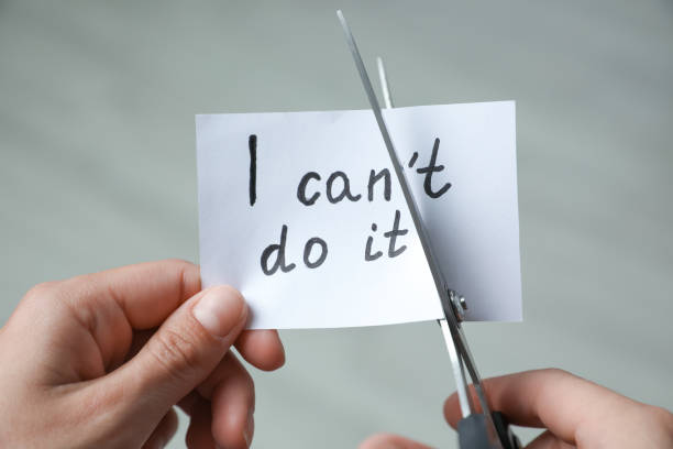 istock Woman cutting paper with text I can't do it on blurred background, closeup 1350822706