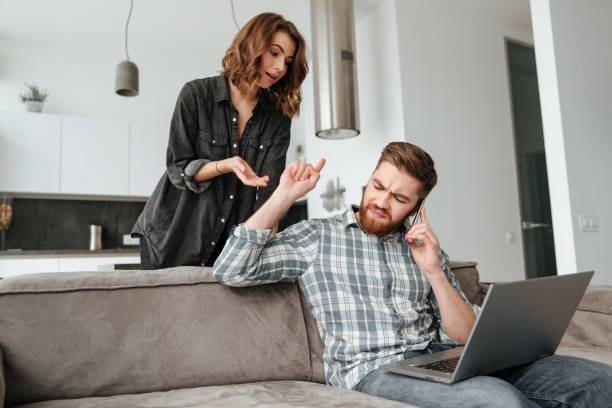 istock Loving couple in kitchen at home indoors. 1350823518