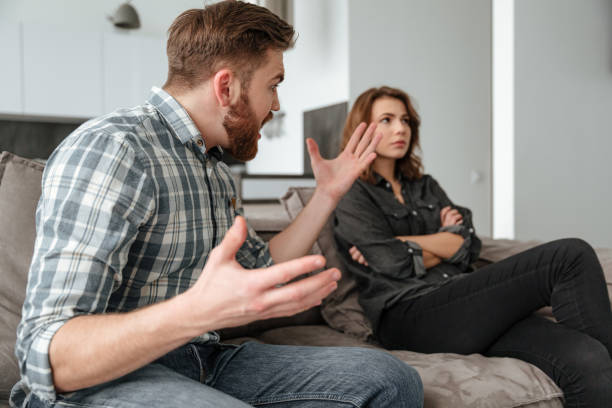 istock Quarrel loving couple on sofa indoors. 1350823552