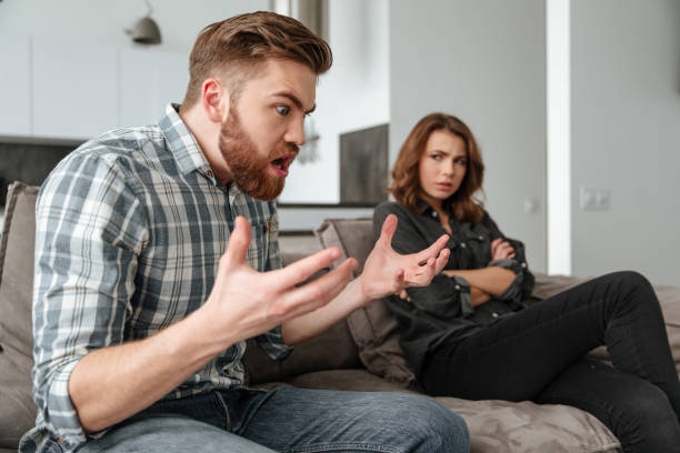 istock Angry quarrel loving couple sitting on sofa indoors 1350823692