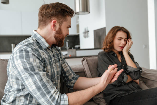 istock Angry young quarrel loving couple sitting on sofa indoors 1350823752