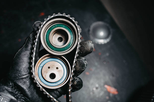 istock automotive timing belt on a black background. Replacement concept for idler pulleys and engine belts. 1350823919
