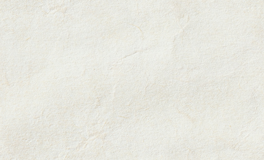Seamless and tileable paper texture background. Close up of vintage off white, rough parchment paper texture