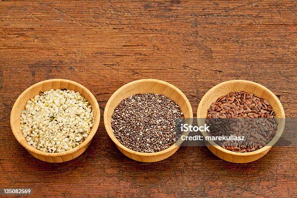 3 Bowls Of Seeds Chia Flax Hemp On Rustic Wooden Table Stock Photo - Download Image Now