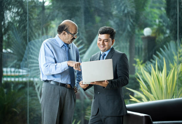 istock Two businessmen discussion at office wile using laptop 1350825789