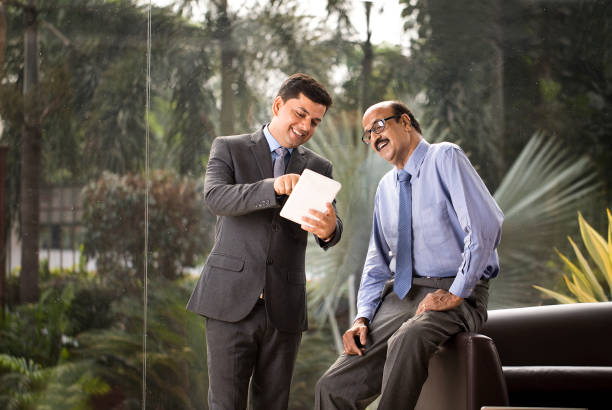 istock Two businessmen discussion at office wile using digital tablet 1350825813