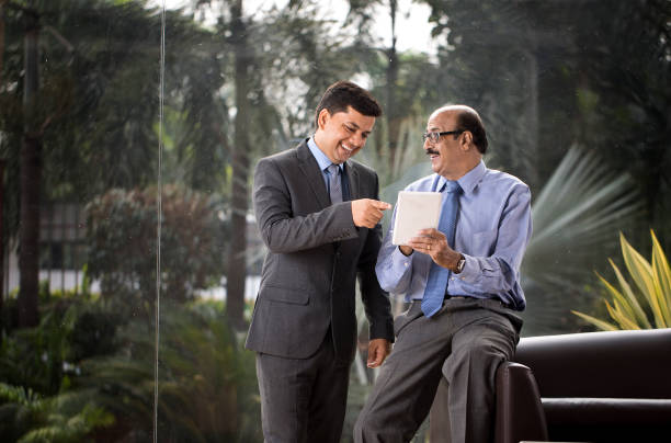 istock Two businessmen discussion at office wile using digital tablet 1350825853