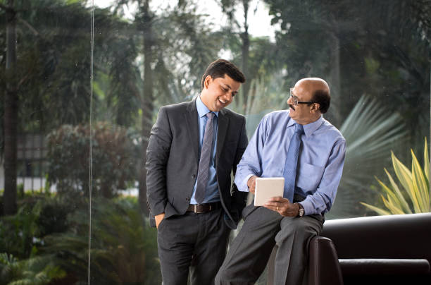 istock Two businessmen discussion at office wile using digital tablet 1350825867