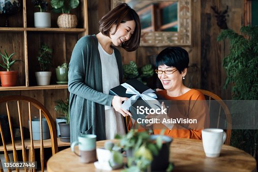 istock A senior Asian mother receiving a present from her daughter at home. The love between mother and daughter. The joy of giving and receiving 1350827445