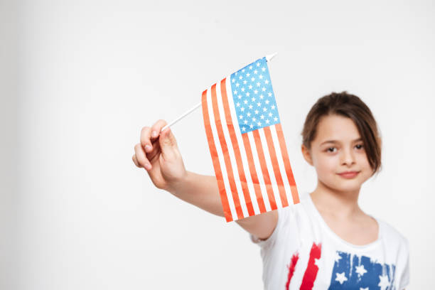 istock Girl holding USA flag 1350827482