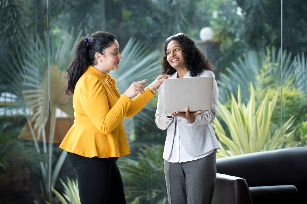 istock Two happy businesswomen discussing at office 1350828003