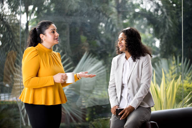 istock Two businesswomen discussing at office 1350828517