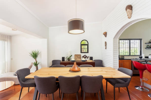 istock Traditional modern Mediterranean dining room, stylish decor with table and chairs. Overlooking the kitchen. 1350829021
