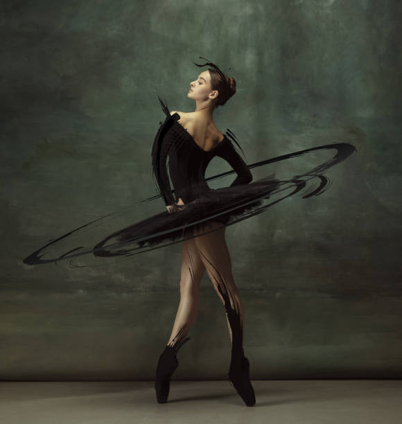 Cinematic portrait graceful female ballet dancer posing isolated on dark vintage studio background with drawings. Sense of pride. Cinematic portrait graceful female ballet dancer posing isolated on dark vintage studio background with drawings. Art, motion, action, inspiration concept. Artwork classical music photos stock pictures, royalty-free photos & images