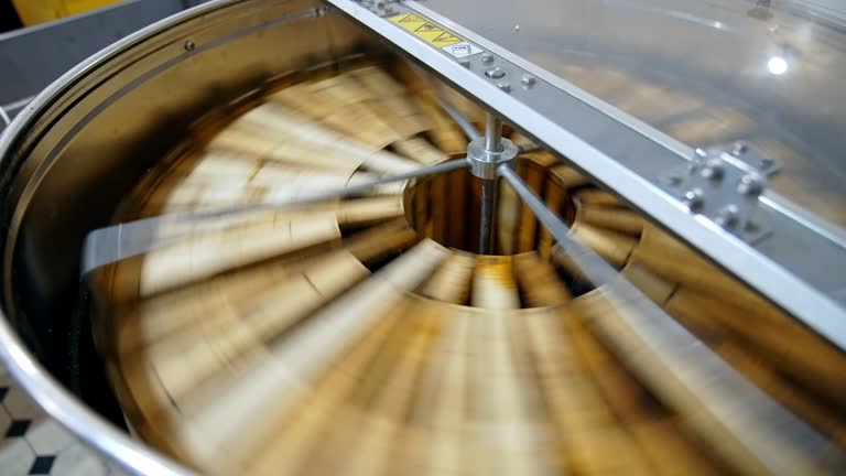 Getting honey from honeycomb. Manual centrifuge device, spinning the honey from cells