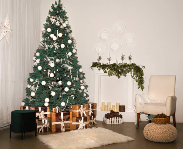 istock Christmas interior with decorative Christmas tree, gift boxes, armchair and fireplace. Christmas background, greeting card. 1350832562