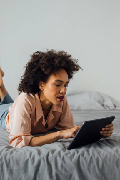 istock Business Woman Using Digital Tablet in her Bedroom 1350834161