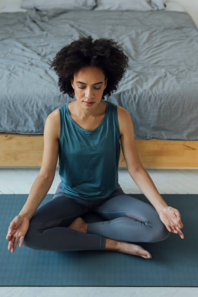 istock Beautiful Woman Practicing Yoga at Home 1350834176
