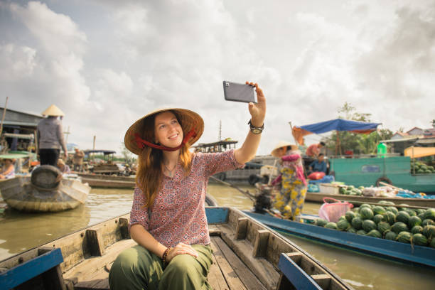 Woman tourist on floating market in Vietnam stock photo