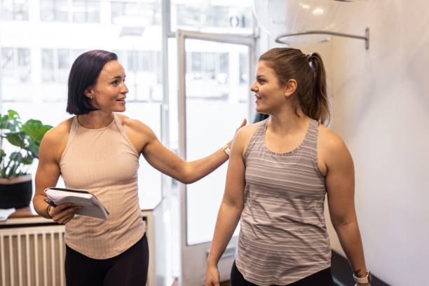 istock Fitness instructor talking with a woman student 1350836179