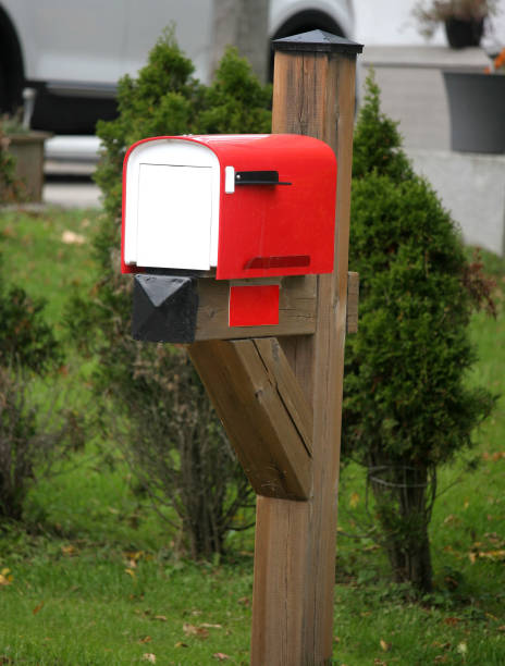 istock Red and white mailbox in rural countryside 1350836229