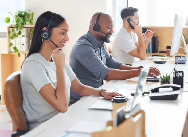 Shot of a group of businesspeople working in a call centre Responding as quickly as possible to all inquiries customer relationship management stock pictures, royalty-free photos & images