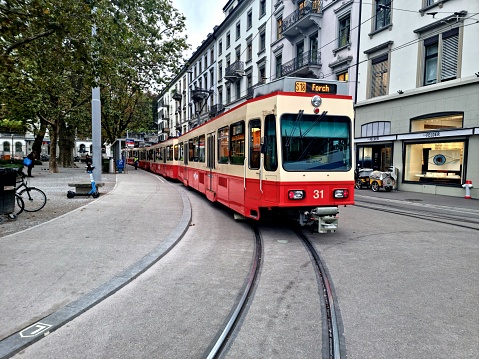 Forchbahn Train Be 4/4 which where manufactured in 1994. The image shows the Train at the final Stop Stadelhofen during autumn season