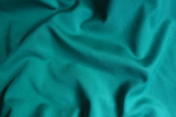 istock Simple blue green polyester fabric in soft folds 1350836801