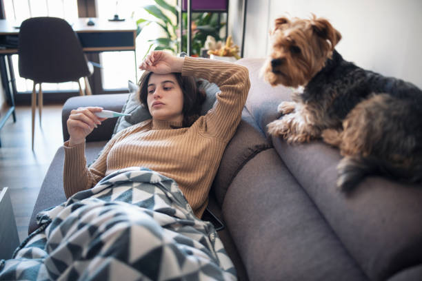 istock Young Sick Woman Lying On Sofa At Home 1350838271