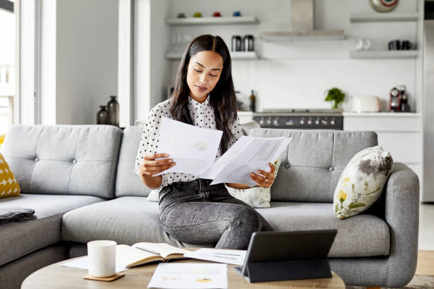 istock Female analyzing financial bills at home 1350838470