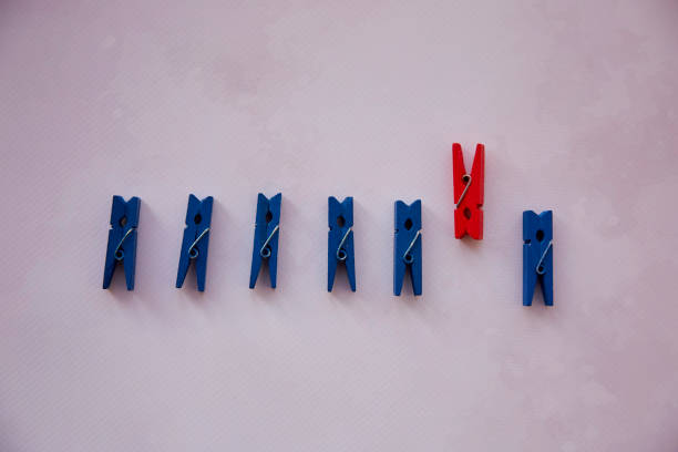 istock Be different and stay different with stationery clothespins concept. Be original - Stand out from the crowd 1350840117