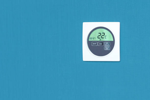 istock Smart home system device on the wall at home with copy space. Concept control temperature in living room. 1350840268