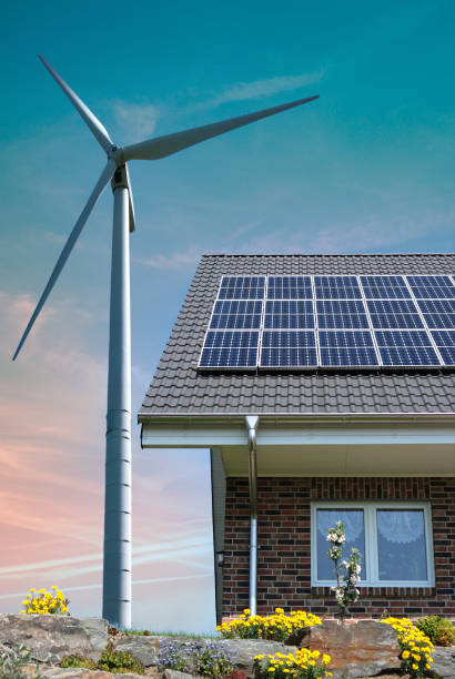 istock Roof with solar panels and wind turbines aside 1350840357