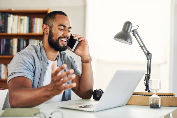 istock Shot of a handsome businessman using his smartphone to make a phonecall while working from home 1350840567