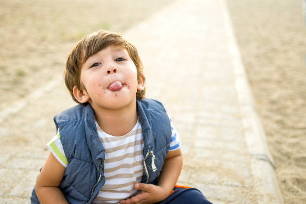 istock Happy child boy enjoying to beach 1350841417