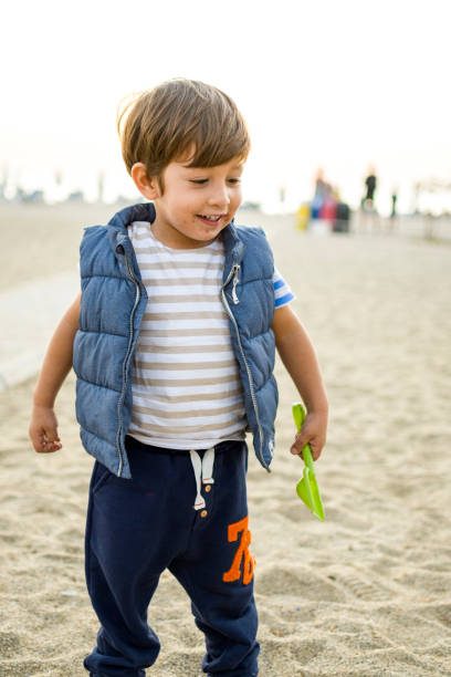 istock Happy child boy enjoying to beach 1350841757