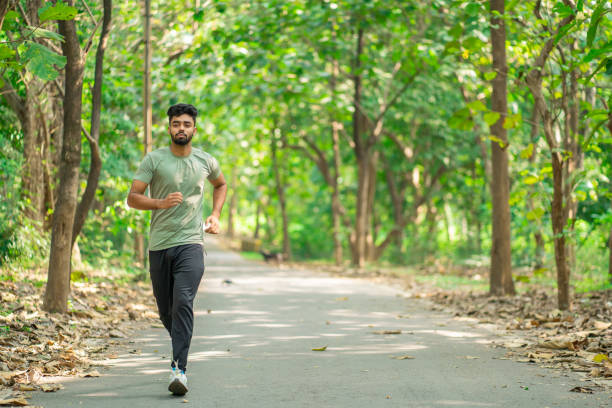 istock Young man running in the park at morning 1350844939
