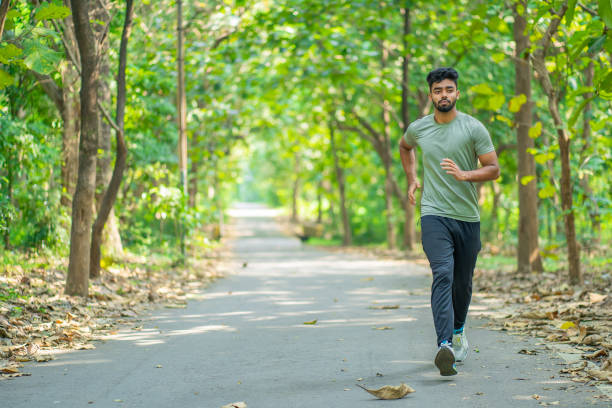 istock Young man running in the park at morning 1350844943