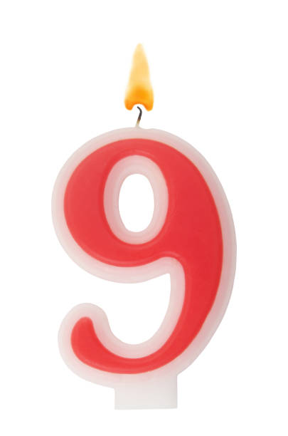 istock Red birthday candle isolated on white, number 9 1350845011