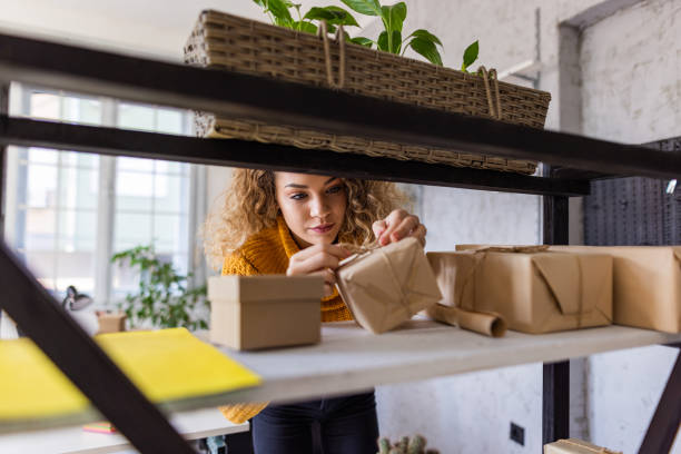 istock Woman packing containers for sending 1350845993
