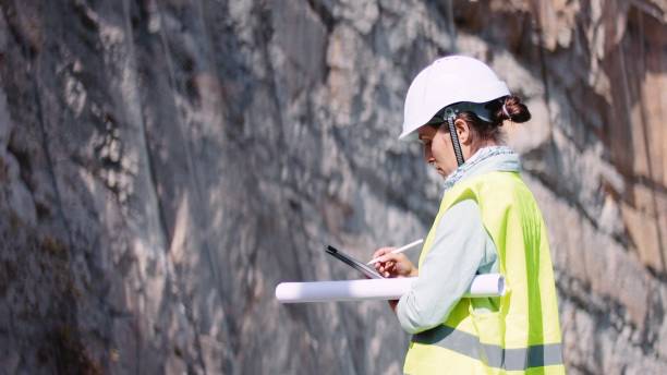 istock Female road construction engineer working. Building new highways. 1350847980