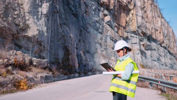 istock Female road construction engineer working. Building new highways. 1350848010
