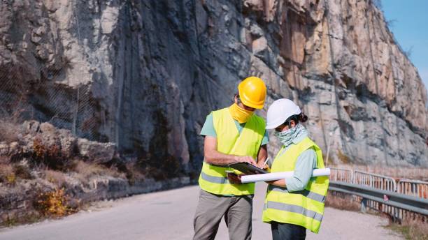 istock Road construction engineers working. Building new highways in COVID-19 pandemic. 1350848014